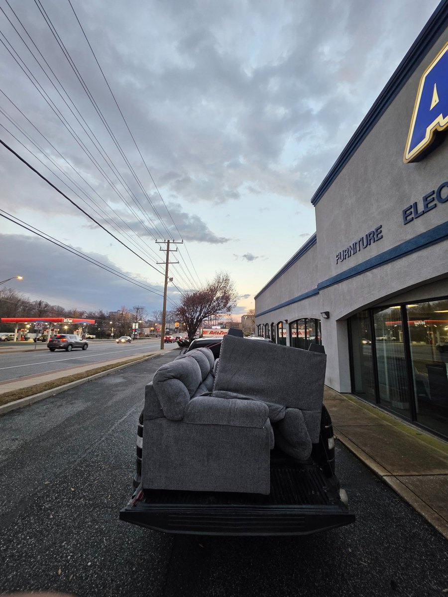 Furniture delivery with couch loaded in pickup truck